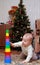 Baby try to pull down colorful pyramid