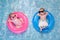 Baby Twin Boy and Girl Floating on Swim Rings