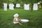 Baby washes white clothes in basin in the garden in nature.