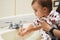 Baby washing hands with water