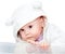 Baby in white bear costume on white