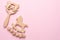 Baby wooden rattles and toys on pink background isolated with copy space