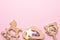 Baby wooden rattles and toys on pink background isolated with copy space