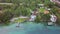 Bacalar, Mexico, 06 October 2017: shot from drone getting away from shore featuring coastal like with hotels, yacht, wooden pier a