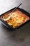 Bacalhau espiritual is a Portuguese casserole prepared with salt cod, carrot, bread, Bechamel sauce and topped with cheese closeup