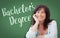 Bachelor`s Degree Written On Green Chalkboard Behind Woman