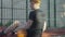 Back angle view of relaxed young Caucasian basketball player sitting on outdoor court and resting. Confident redhead man