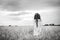 Back of a beautiful girl in a wheat field with long hair and a wreath.