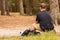 Back biew on the Caucasian young man sitting in the forest