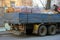 Back of big flatbed truck with side body loaded with building materials