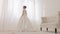 Back of bride in white elegance wedding dress with loop. Video. Full length. Wedding. Beautiful bride indoors with