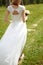 Back of the bride in a white wedding dress close-up. Bride fees, wedding ceremony, wedding salon, dress shop for the celebration.