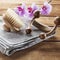 Back brush and towel on wood background for massage and exfoliation