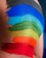 Back of a child painted with rainbow
