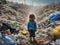 The back of a child standing and looking at a pile of garbage on the beach Conceptual view of a beach full of human waste.