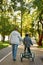 Back of dad help son with disability ride tricycle