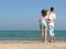 Back family of three on beach