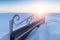 The back forged snow-covered benches.