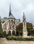 The back front of the Notre Dame de Paris church in a rainy day against the overcast sky