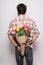 Back Handsome young man with beard and nice bouquet of flowers