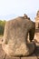 Back of Headless Statue at Borobudur Temple with mountain range in the background