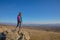 Back hiker woman standing on rock in Madrid mountain looking at the valley