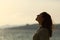 Back light of woman silhouette breathing fresh air on the beach