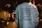 Back of a male wearing a sweatshirt with a poem written on it walking on the street