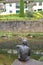 Back Of The Man Statue Fish Next To The Lovely Roman Bridge In Lierganes. August 24, 2013. Lierganes, Cantabria. Vacation Nature