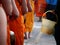 Back of The Monk Holding The Bowl Walking in The Line and Teenagers Holding a Plastic Bucket