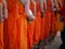 Back of The Monk Holding The Bowl Walking in The Line and Teenagers Holding a Plastic Bucket