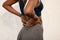 Back pain, fitness and closeup of black woman in gym for muscle, ache and inflammation. Healthcare, emergency and