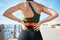 Back pain, red fitness and woman at beach exercise or sports injury, emergency and healthcare risk. Medical, spine and