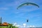 Back of the paragliding man in blue sky at Camboinhas Beach, Niteroi, Rio de Janeiro, Brazil