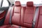 Back passenger red leather seats in modern luxury car. Red perforated leather with stitching. Car inside. Leather comfortable red