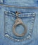 Back pocket of jeans with handcuffs