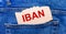 In the back pocket of the jeans there is a brown piece of paper with the text IBAN International Bank Account Number