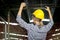 The back of Portrait of beautiful young female industrial engineer worker wearing safely helmet raising hand up at manufacturing i
