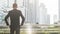 the back portrait silhouette smart business man stands with confident at the outdoor space with the city building background