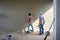 Back portrait of workers plastering the cement texture