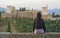 Back portrait of young beautiful and relaxed woman having Summer holidays in Spain enjoying cheerful beautiful view at Alhambra of