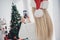 Back rear view photo of young girl shoot picture cellphone christmas tree decor atmosphere winter holiday indoors