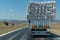 Back rear view of truck full of hay bales in traffic