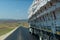 Back rear view of truck full of hay bales in traffic