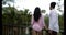 Back Rear View Of Young Couple Standing On Summer Terrace Enjoying Landscape Of Tropical Forest Mix Race Man And Woman
