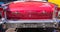 Back of a red classic american Oldsmobile car