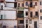 Back side of an abandoned brick apartment building in Manhattan, revealing urban decay, the fire escape and graffiti on