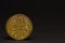back side from a golden valuable bitcoin with black background left