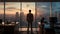 Back side of a hopeful man standing in an office area in front of window