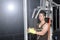 Back side od strong muscular asian man lifting weights exercise his breast in fitness gymnasium,sport and healthy concept